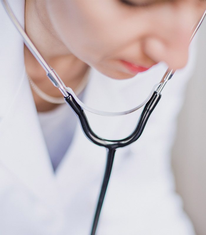 Female doctor using stethoscope